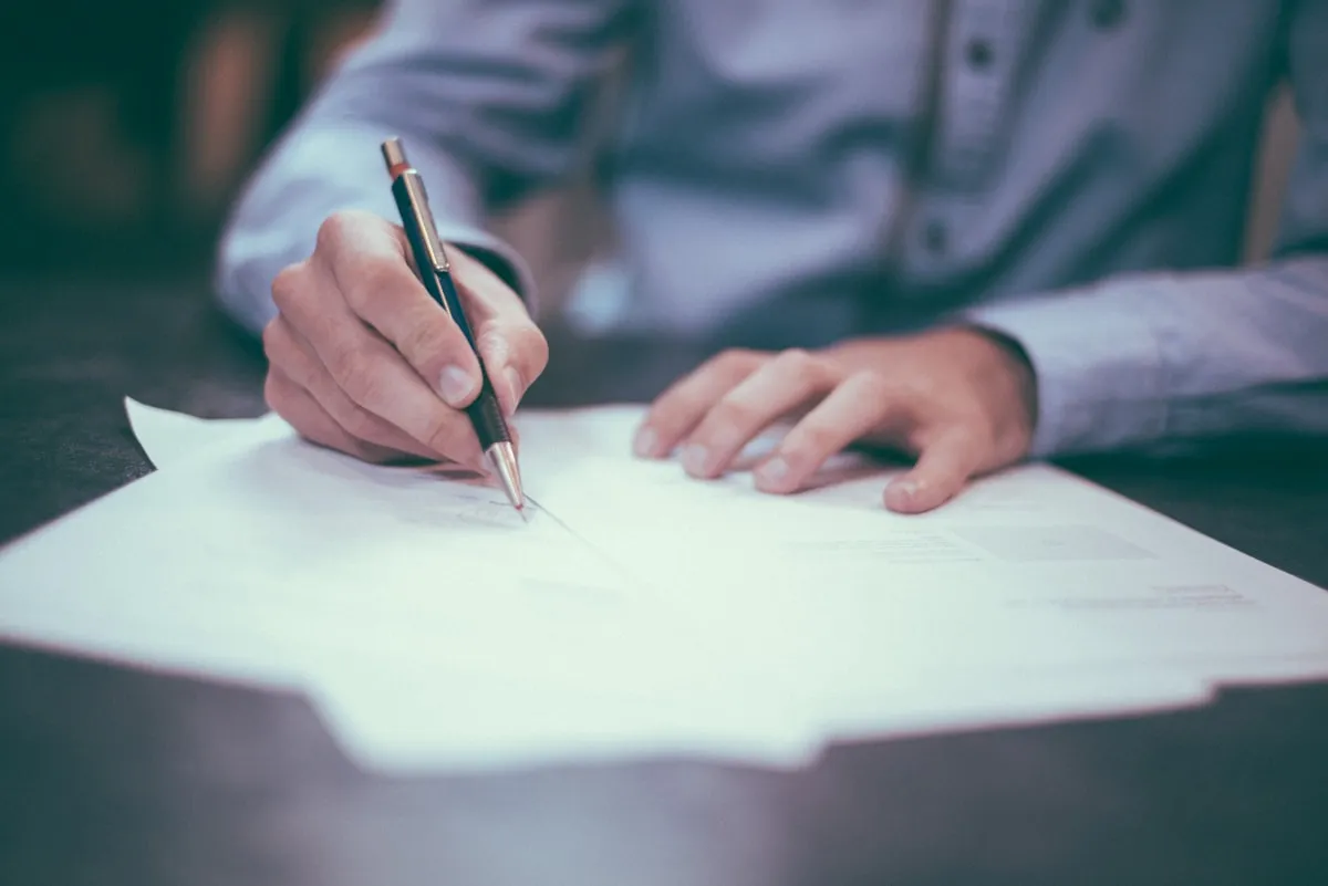 A sealed legal envelope on a desk next to a pen, representing an ADA compliance demand letter.