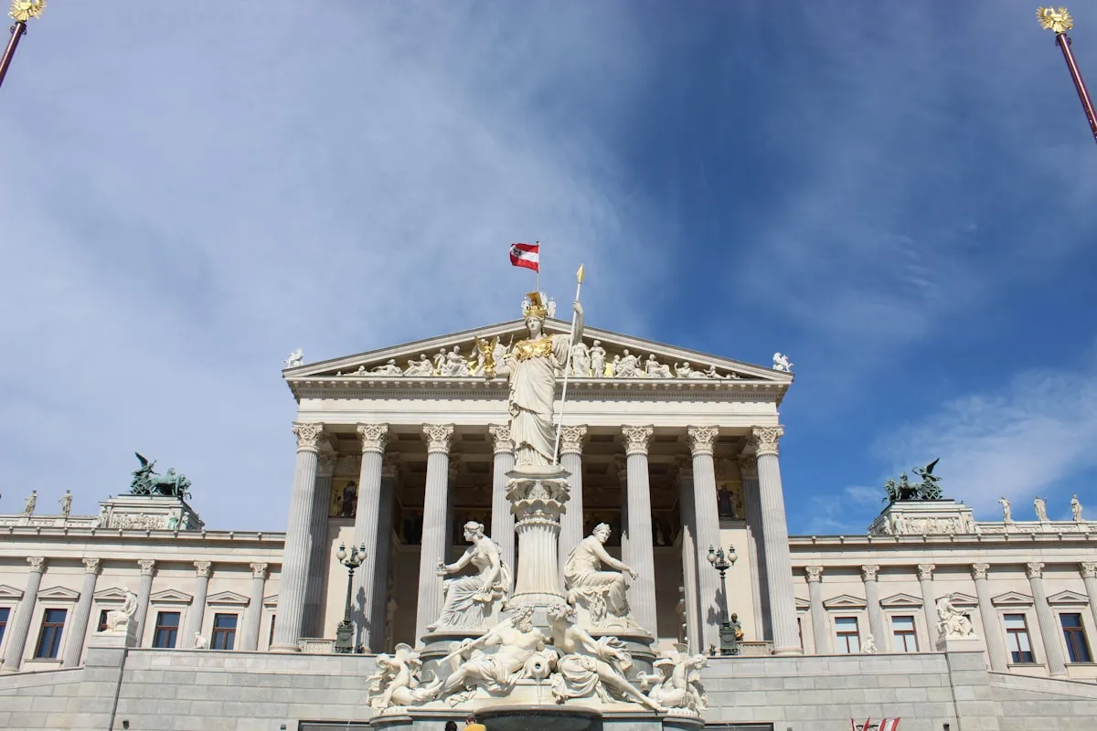 The Austrian Parliament building with classical columns and the Pallas Athena fountain, representing EU public sector governance.