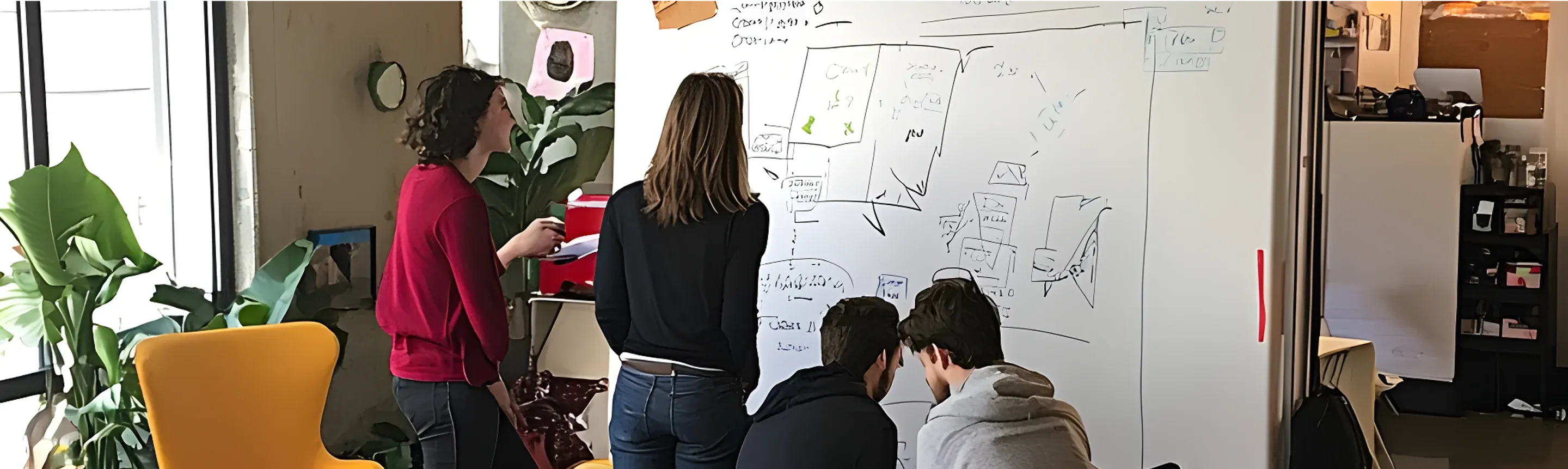 A team of professionals collaborating around a table, reviewing documents related to a digital accessibility policy.